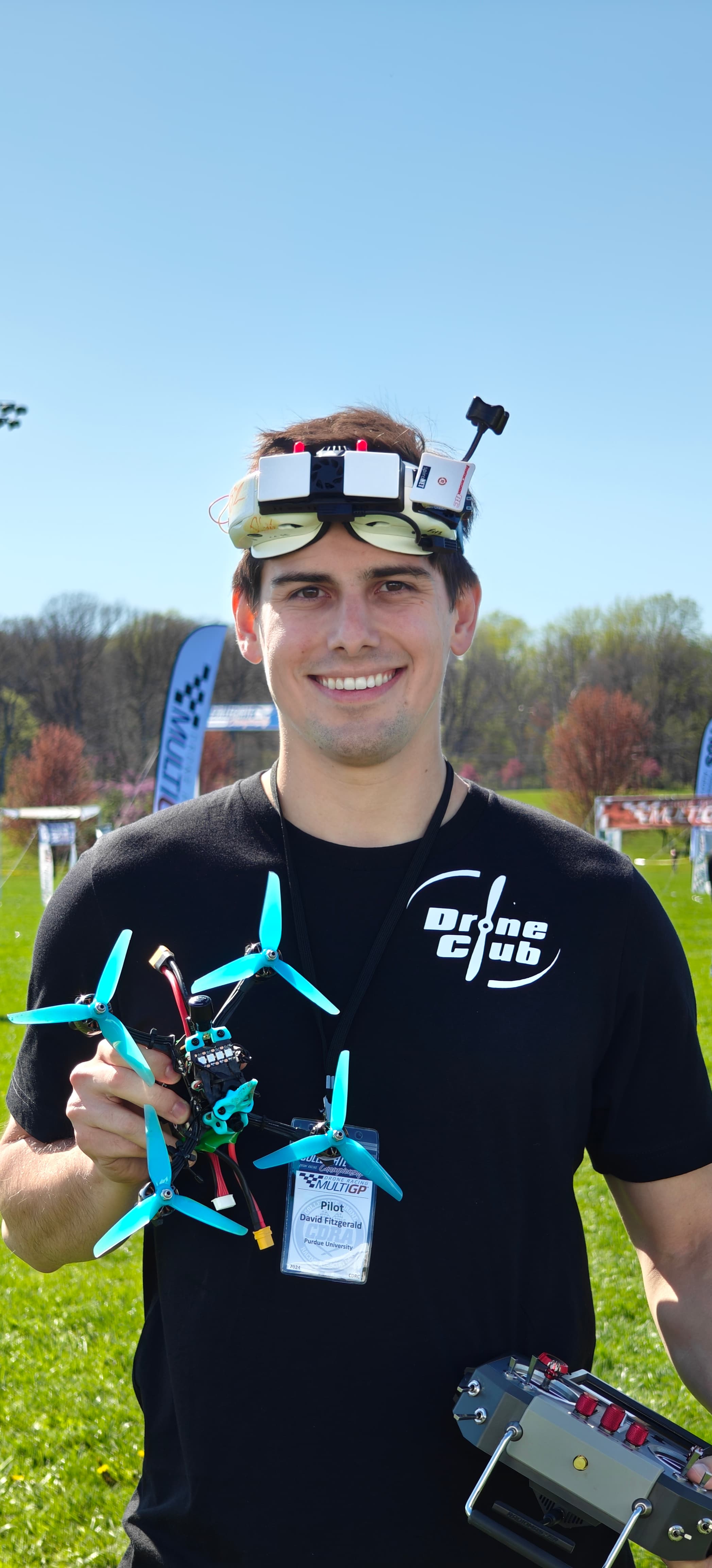 David Fitzgerald holding an FPV drone at a field event